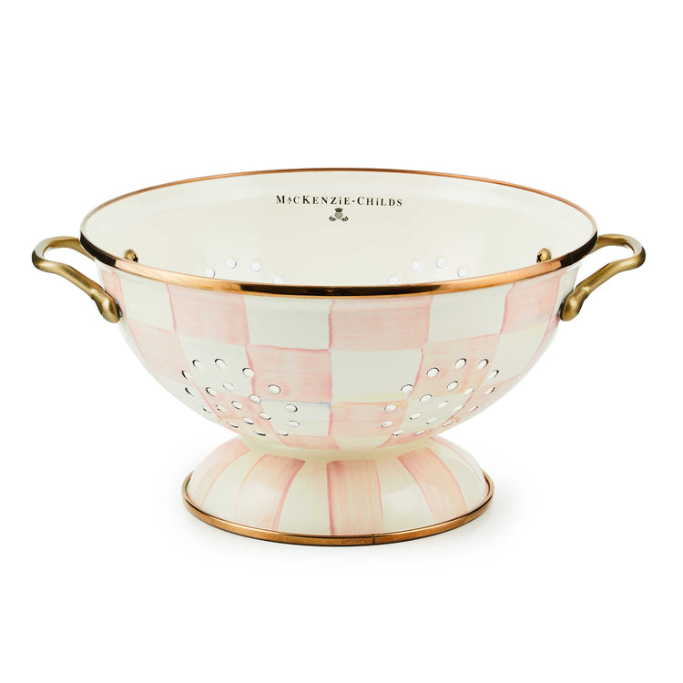 Large hand-painted pink and white checkered colander with bronzed rims and brass handles.