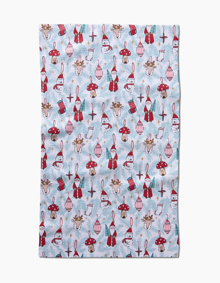 Holiday tea towel with waffle weave construction in red featuring a festive snowflake pattern.