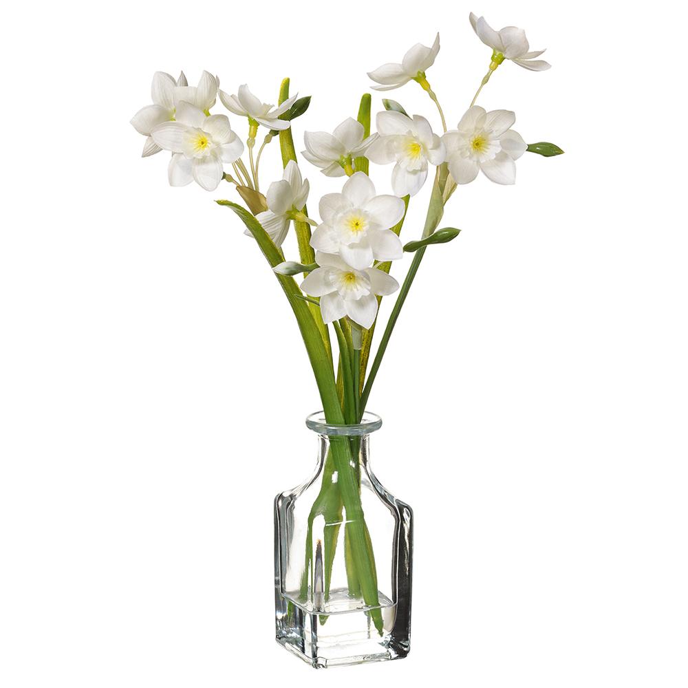White daffodil flower in a clear glass vase with wire stem support