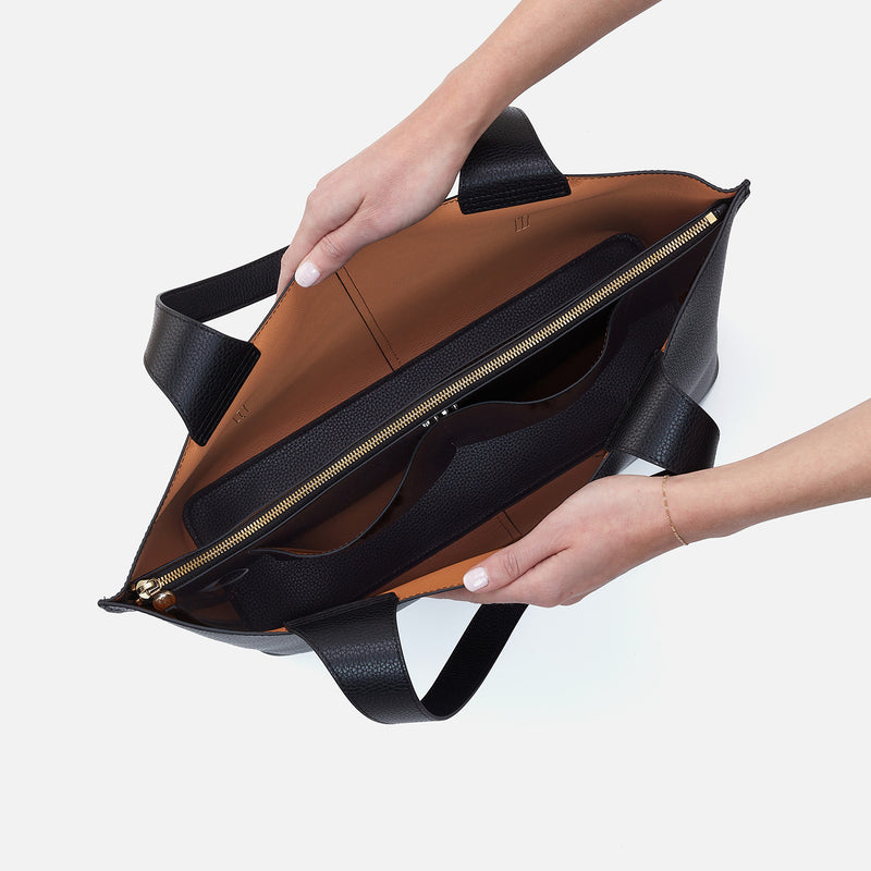 Vida Large Tote in solid leather with brushed antique brass hardware, coconut shell interior lining, and double straps.