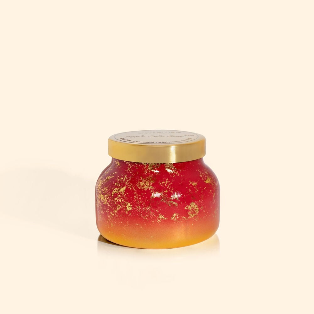 Apple Cider Social Glimmer Petite Jar candle in a clear glass jar with silver glitter accents and a black wick.