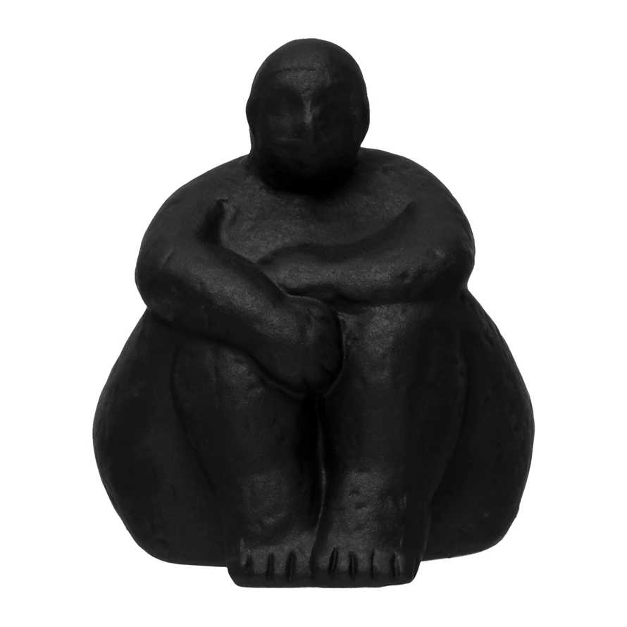 Stoneware sculpture of a woman sitting with arms resting on knees
