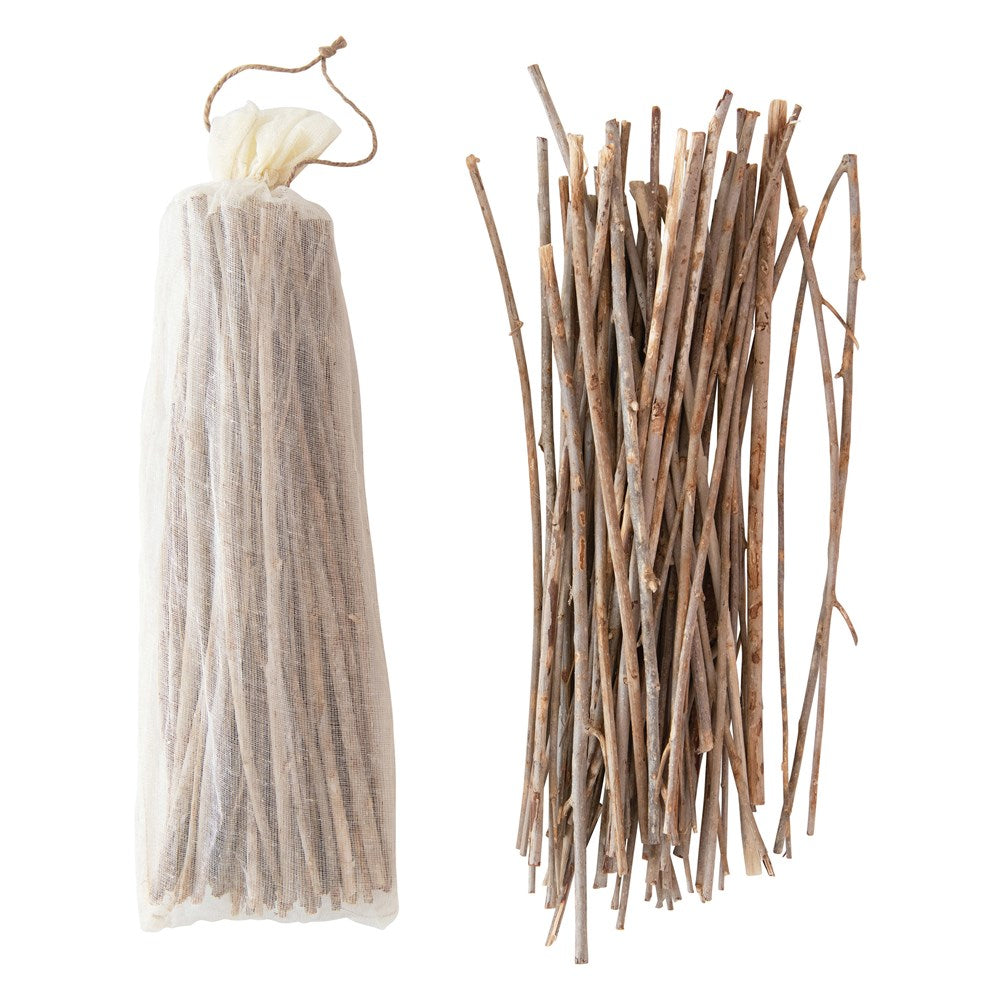 Drawstring cotton bag filled with dried twigs in a natural brown hue