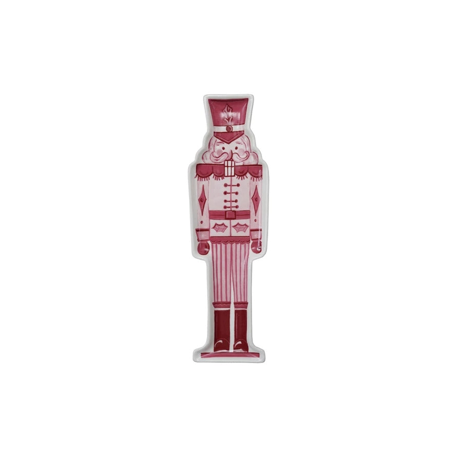 Stoneware nutcracker-shaped plate with a detailed soldier figure silhouette in earthy tones.