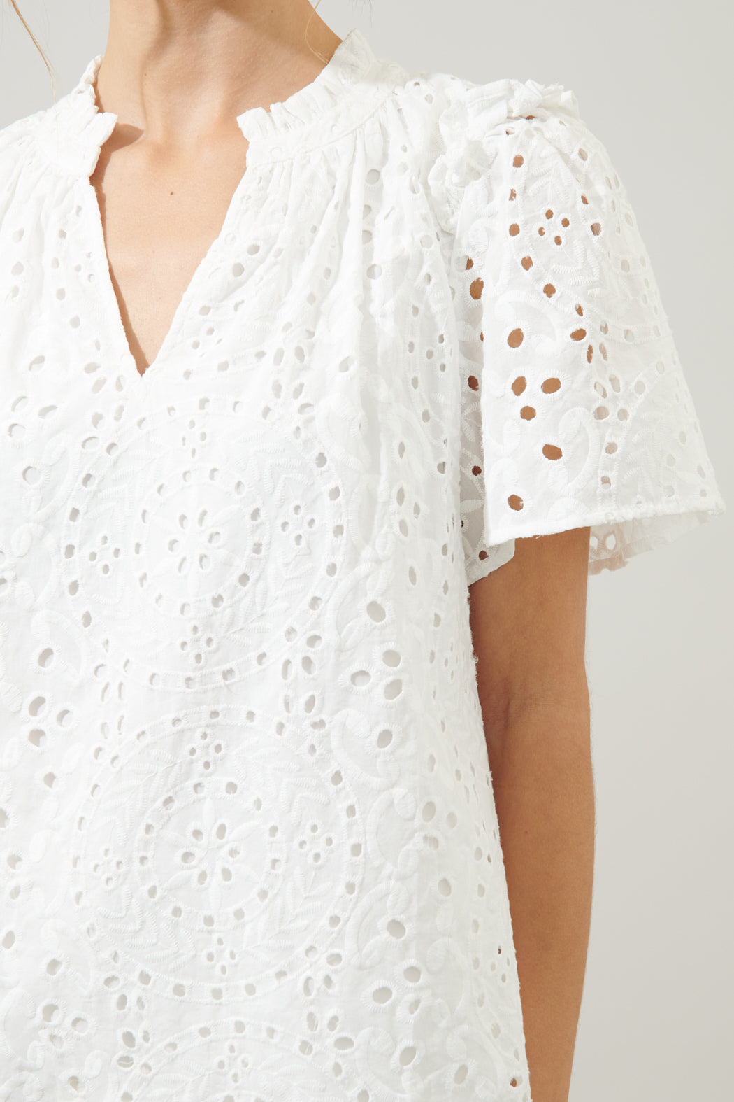 Faye Rain or Shine Eyelet Top in white cotton with a split neckline and relaxed silhouette.