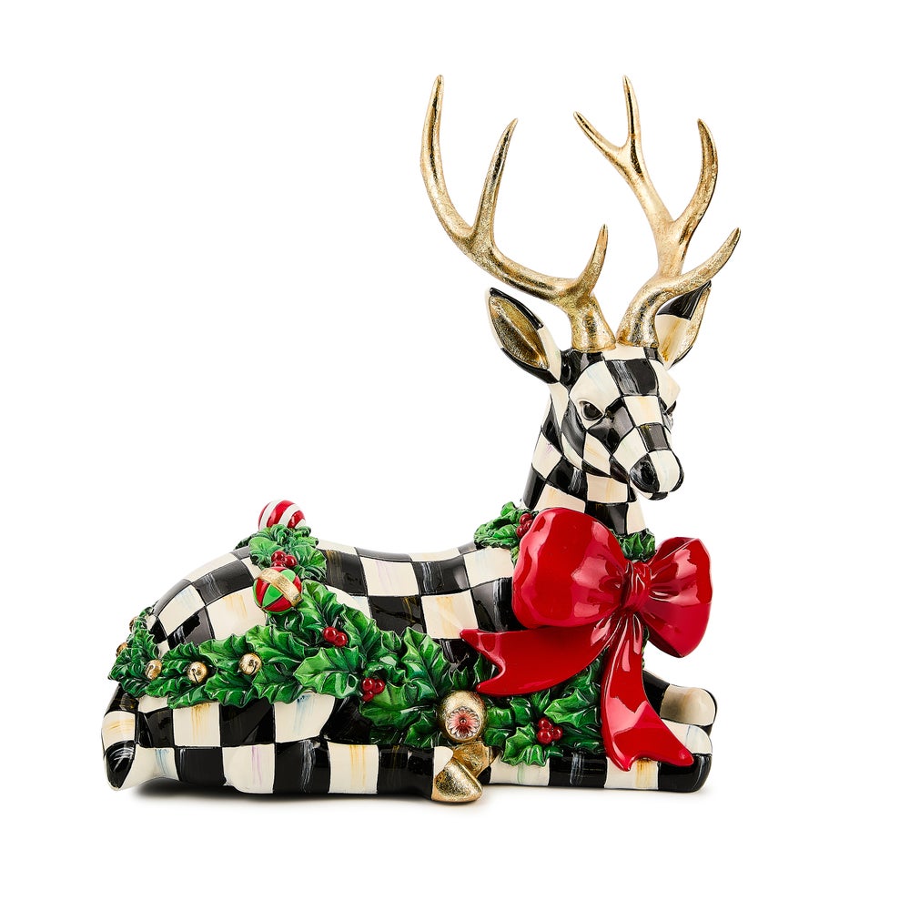 Holly Check Resting Deer figurine with black and white checks, gold antlers, and a red bow.