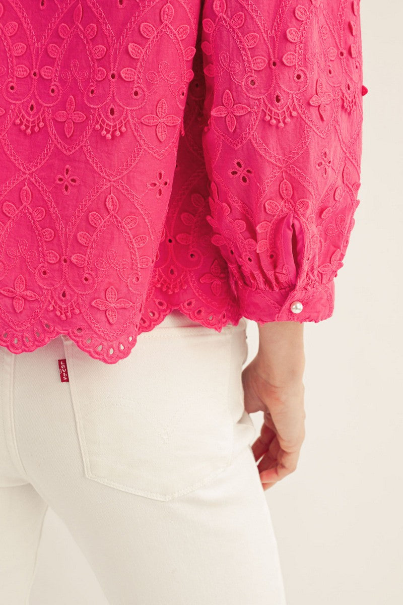 White cotton Ariana top with v-neck, three-quarter sleeves, scallop hem, and 3D lace pattern.