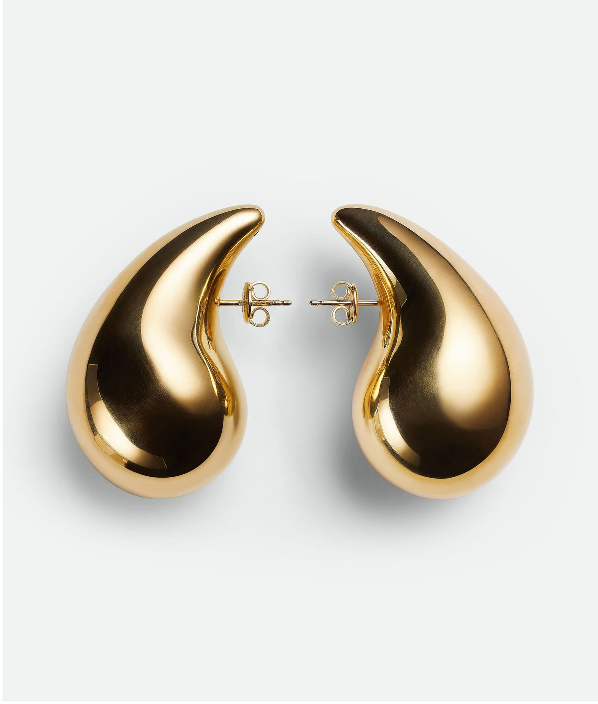 Metal stud earring featuring a three-dimensional tear-shaped charm with an irregular silhouette.