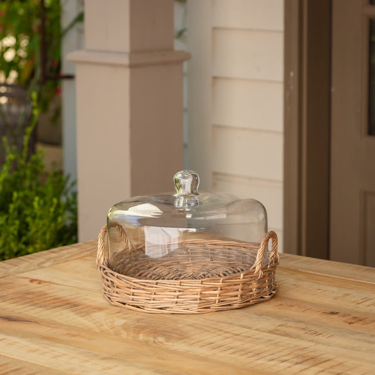 Large cloche covered basket with a domed lid in natural woven material.