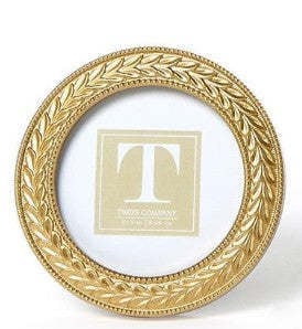 Round gold resin photo frame featuring an intricate laurel wreath pattern with a glass front.