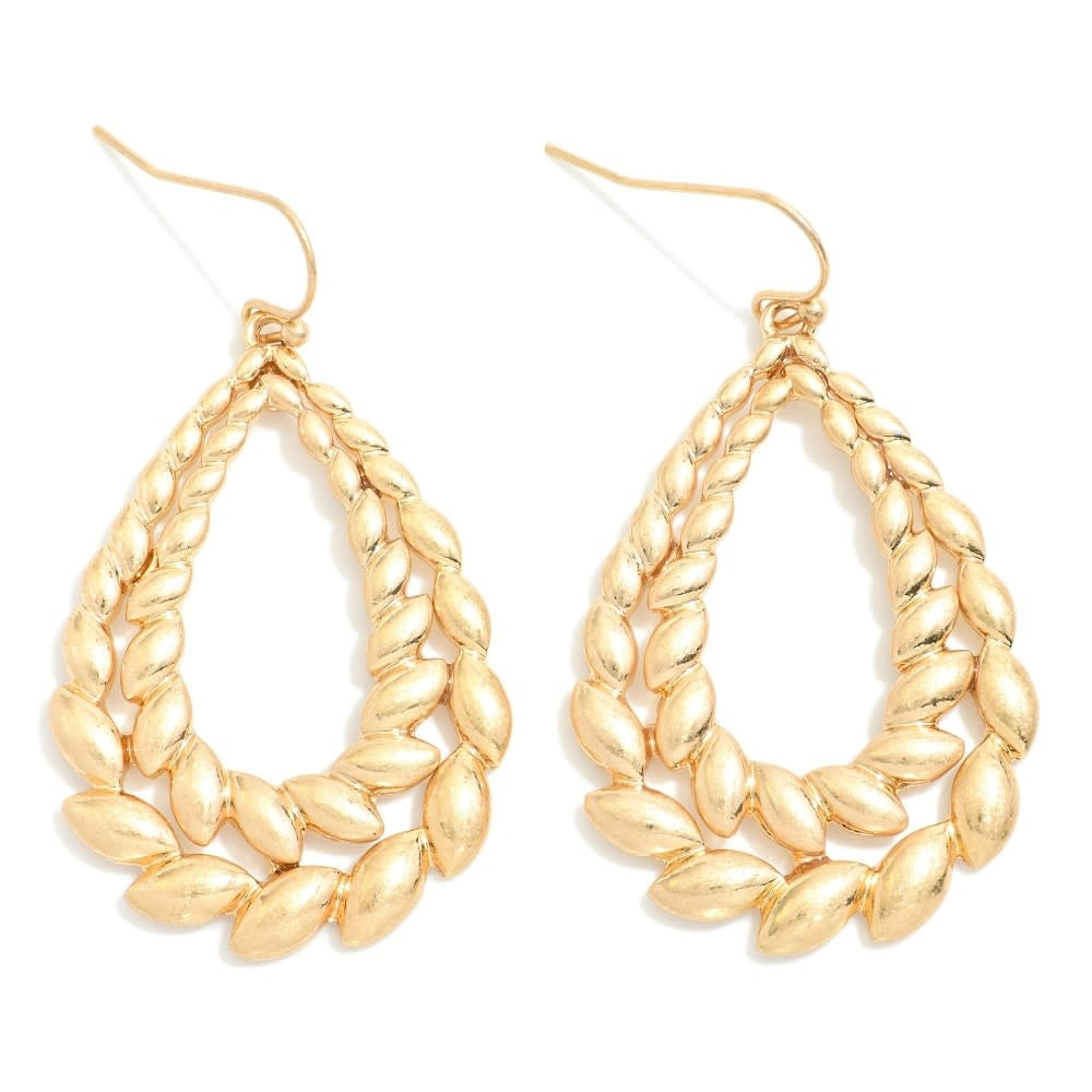 Layered metal teardrop drop earrings with seed-like accents