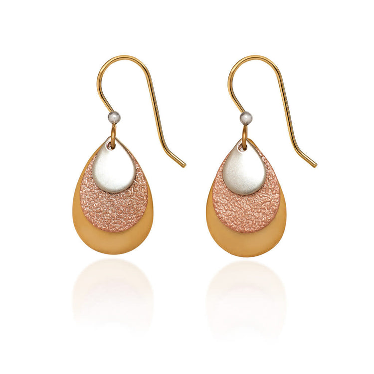 Layered triple teardrop earrings with silver, copper, and gold hammered metal finishes on surgical steel earwires.