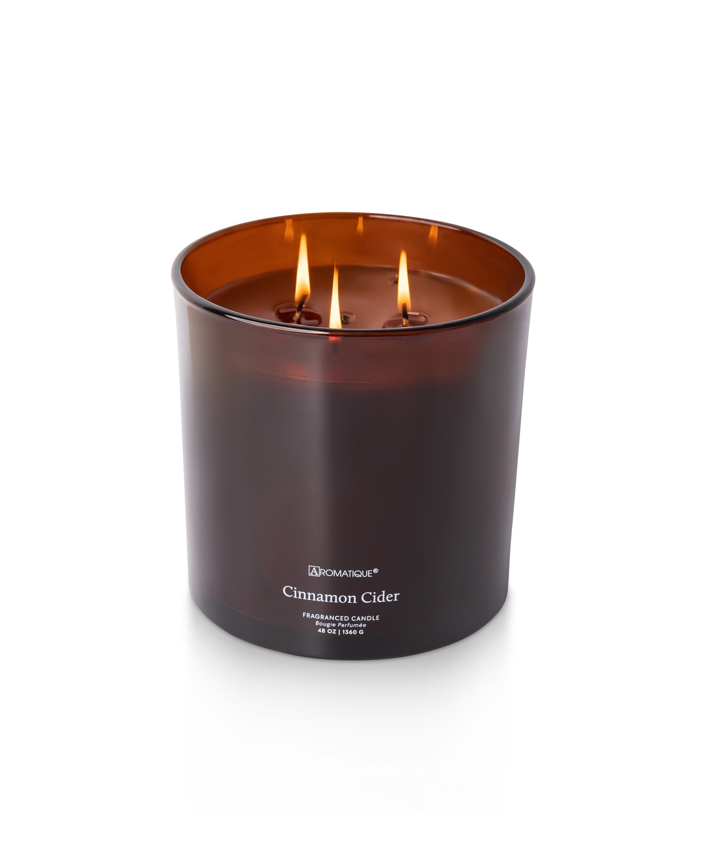 Cinnamon Cider 48 oz three-wick candle in a large amber glass vessel with lit flames.