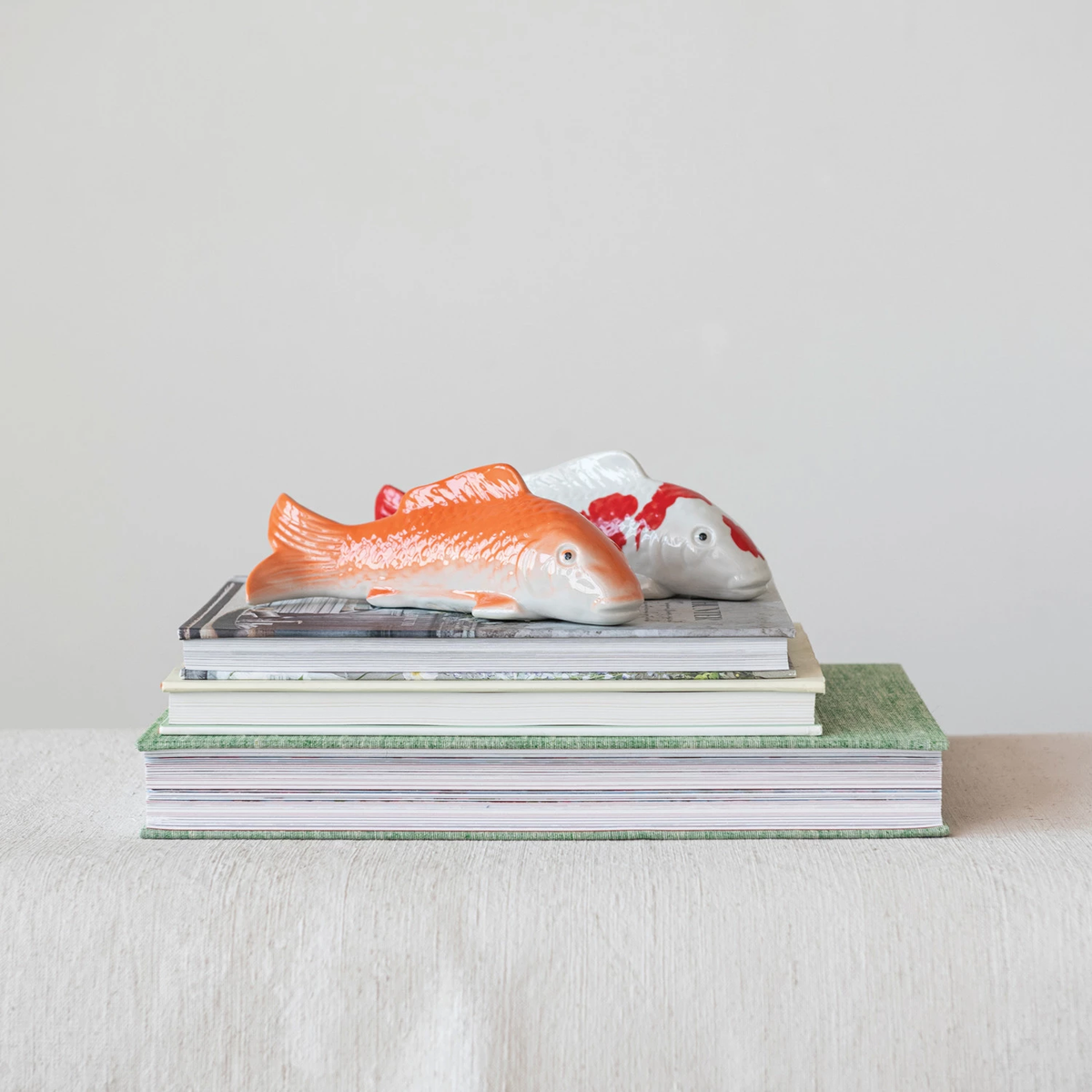 8-inch stoneware floating fish figurine in natural earth tones with a smooth silhouette.