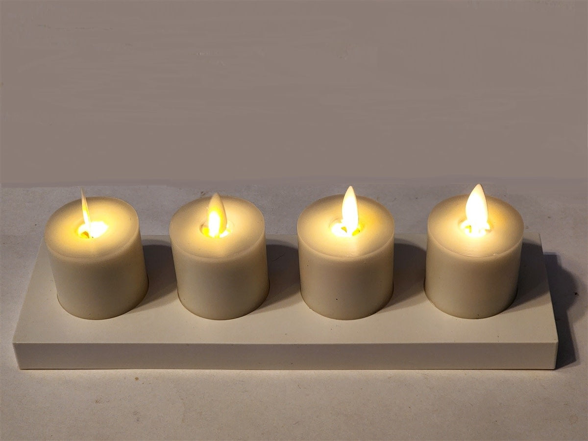 Set of four cream paraffin wax tealights with realistic moving flames on a charging base.