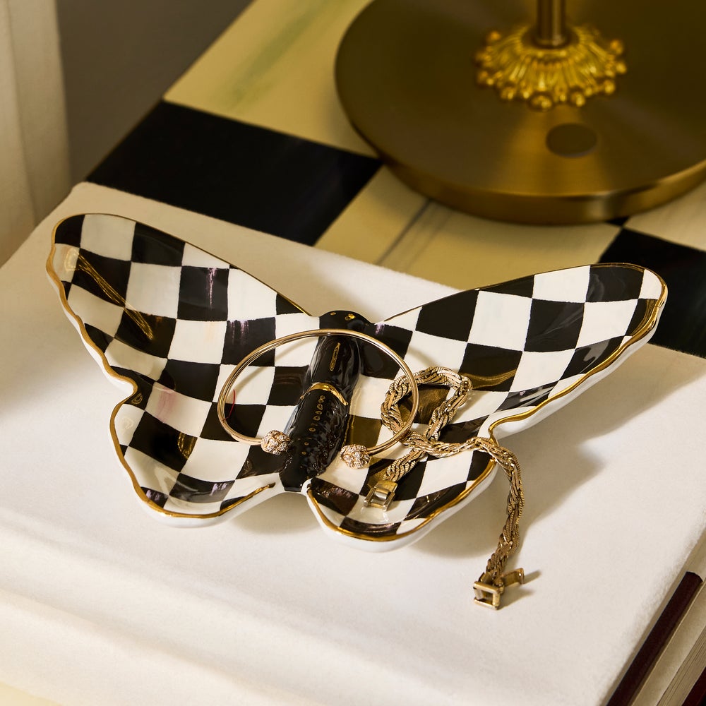 Hand-painted ceramic butterfly trinket dish with black and white checks and gold lustre accents.