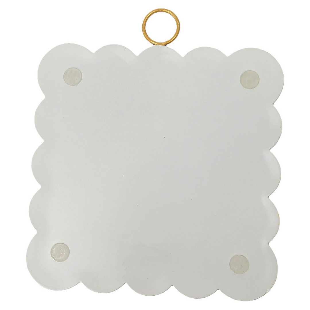Back view of a white scalloped mini art piece with four protective pads and a gold hanging ring.