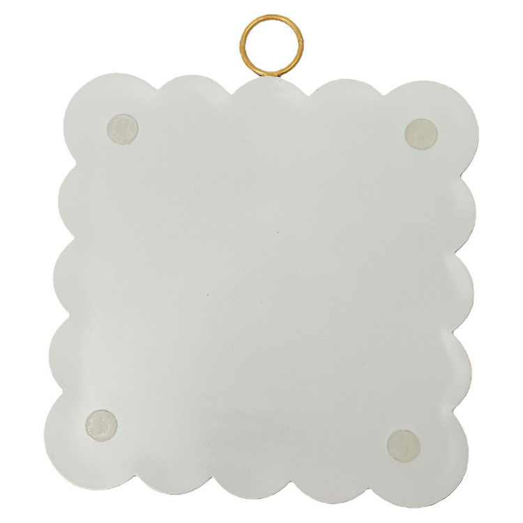Back view of a white scalloped mini art piece with four protective pads and a gold hanging ring.