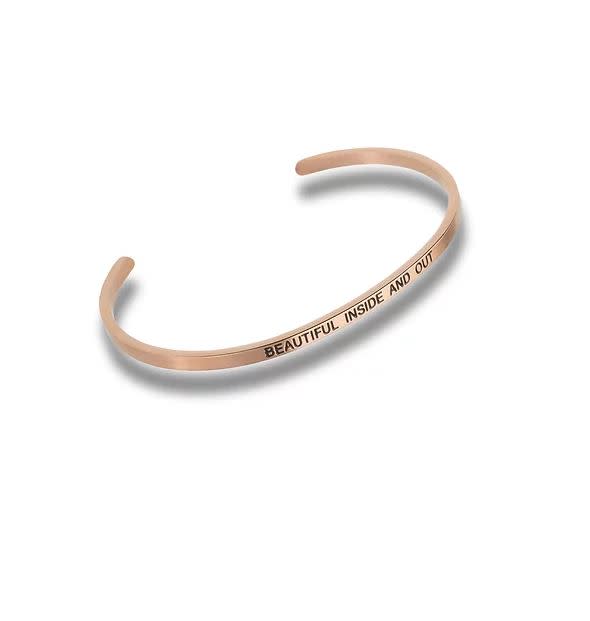 Rose gold cuff bracelet engraved with the words BEAUTIFUL INSIDE AND OUT.