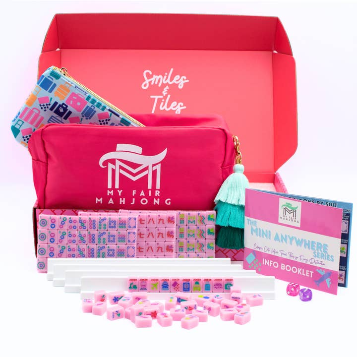 Mini Travel Mahjong set with pink tiles, white racks, dice, and a pink carrying case in a gift box.