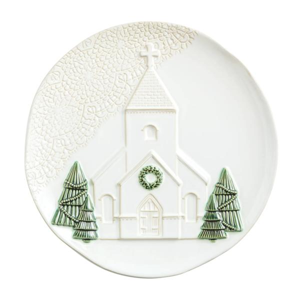 White stoneware platter with a raised church design, green trees, and a decorative lace pattern.