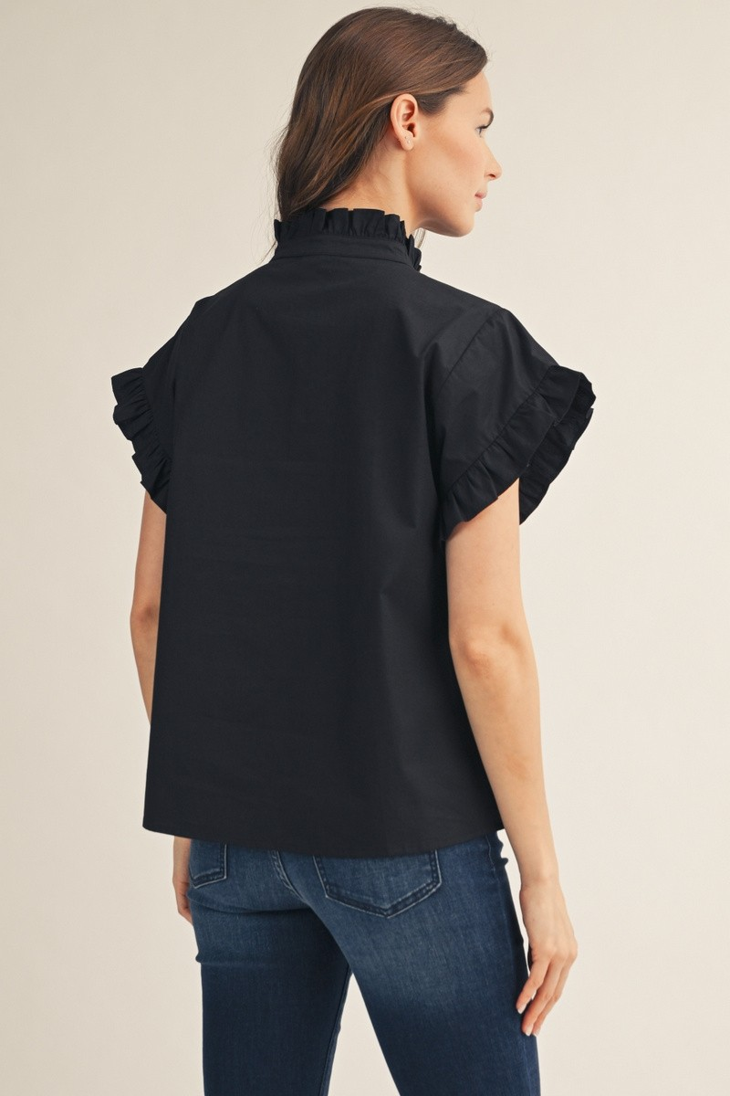 Back view of a woman wearing the black Elise Ruffled Detail Woven Top with blue jeans.