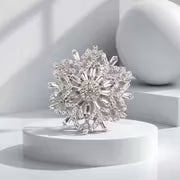 Silver-tone brooch featuring a sparkling rhinestone snowflake pattern with an elegant silhouette.