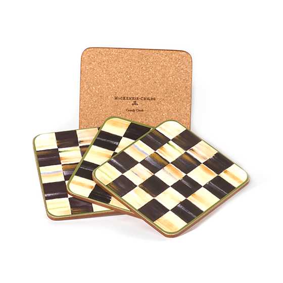 Set of four square coasters with a black and white checkered pattern and natural cork backing.