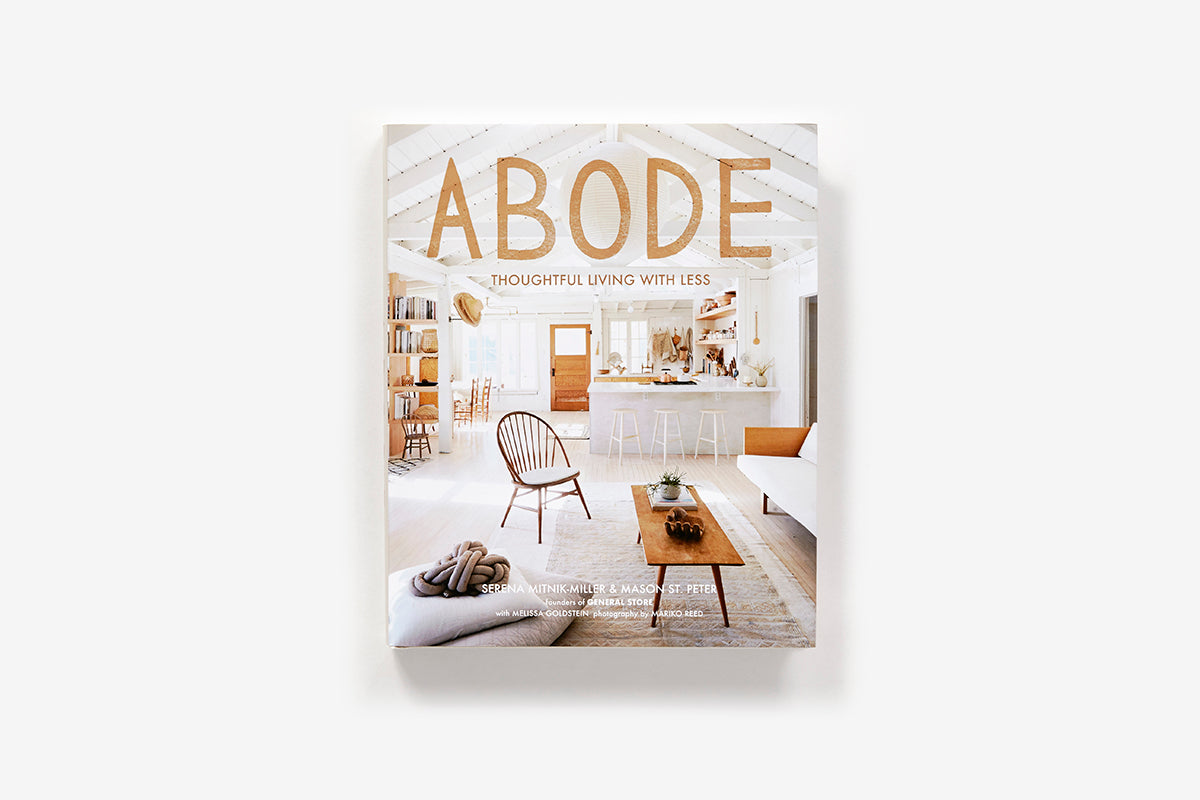 Abode: Thoughtful Living with Less book cover featuring a bright, airy interior with a kitchen and living area.