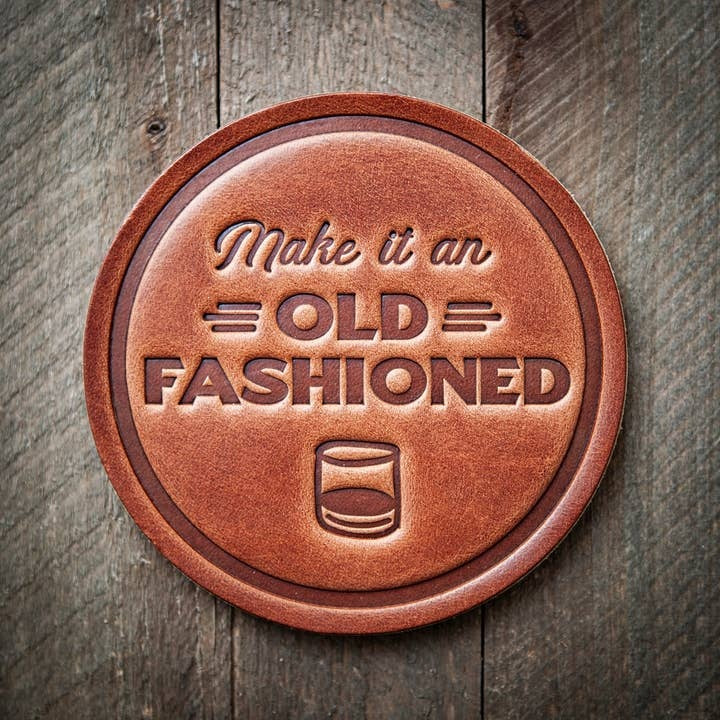 Square brown leather coaster with a textured surface