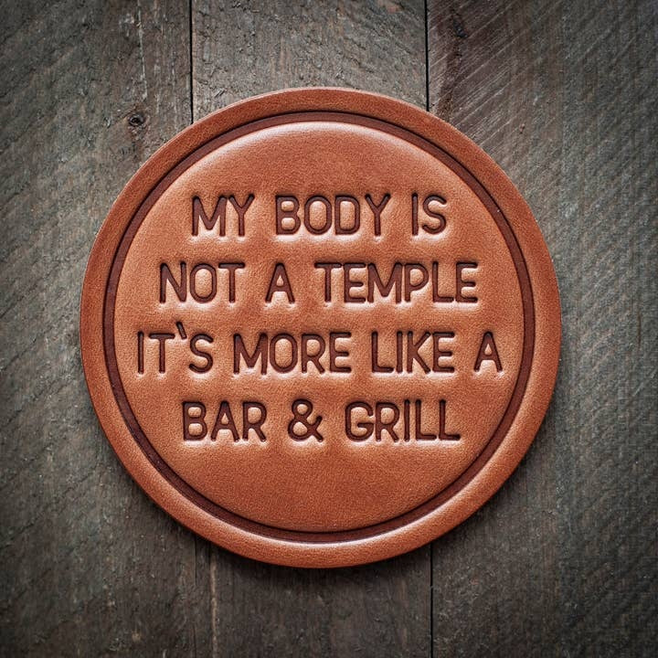 Square brown leather coaster with a smooth texture.
