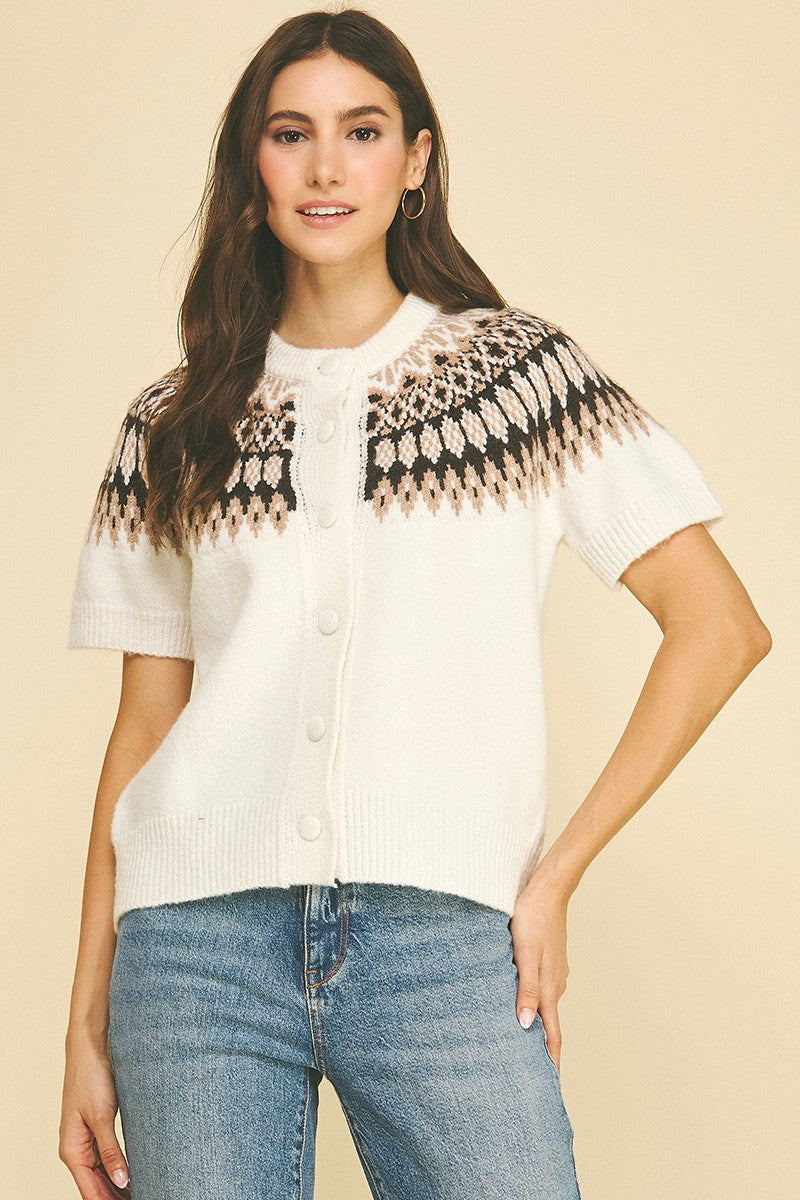 Woman wearing the Jessica Nordic short sleeve knit cardigan in white with a brown and black pattern.