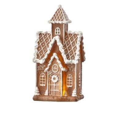 Gingerbread house-shaped LED light with battery compartment and timer switch on festive holiday display.