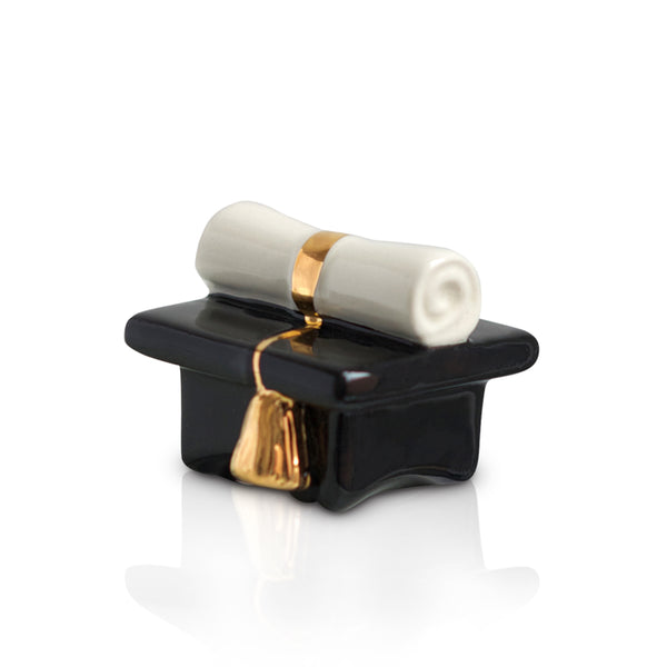 Ceramic graduation cap figurine in black with a white scroll and gold tassel.