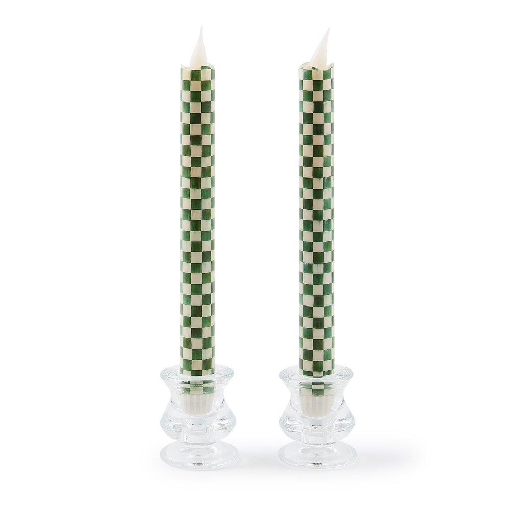 Two emerald green flameless dinner candles with a checkered pattern on wax exteriors and plastic centers.