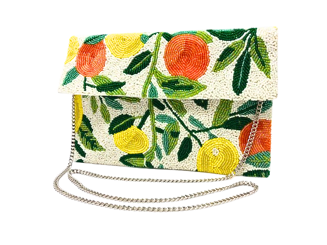 Handmade beaded clutch with lemon and orange fruit patterns on a white background with silver chain.
