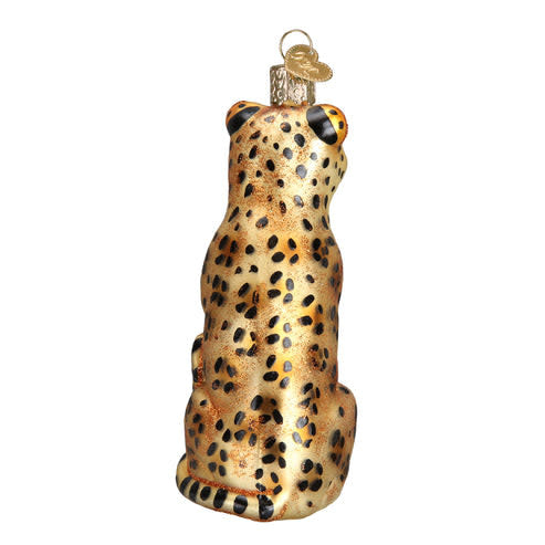 Leopard ornament figurine with spotted coat in tan and black tones on a dark base.