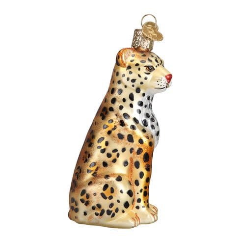 Leopard ornament figurine in tan with black spots standing on a textured base.