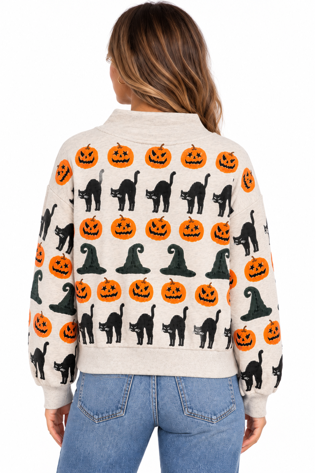 Back view of a woman in a mockneck sweatshirt with witch hat, pumpkin, and black cat patterns.