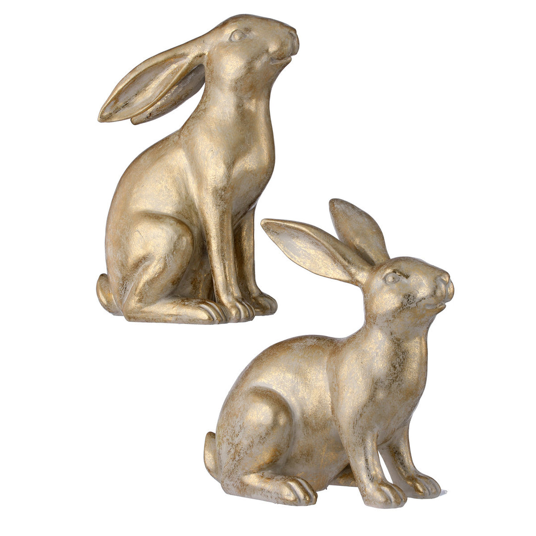 Two decorative golden resin bunny figurines in sitting poses with a distressed metallic finish.