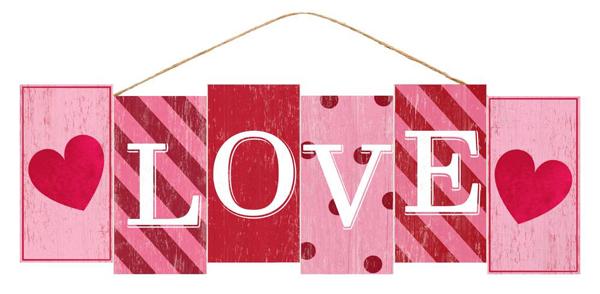 Pink MDF love block sign with white lettering on a rectangular shape.