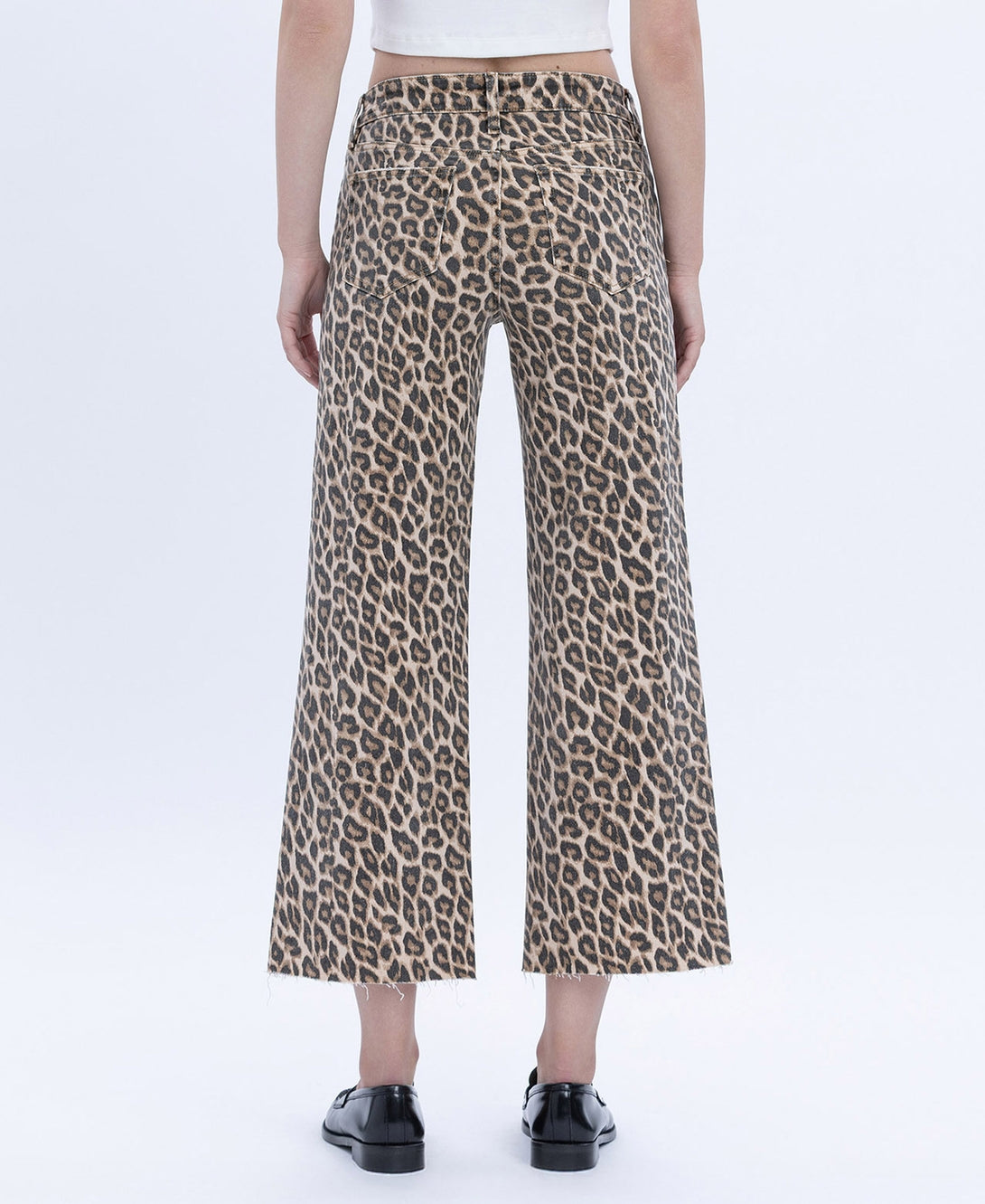 Women's high-rise wide-leg jeans in animal print with raw hem.