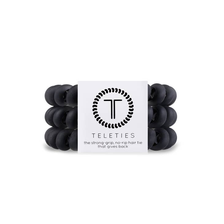 Three large black spiral hair coils with a thick bracelet-style grip.