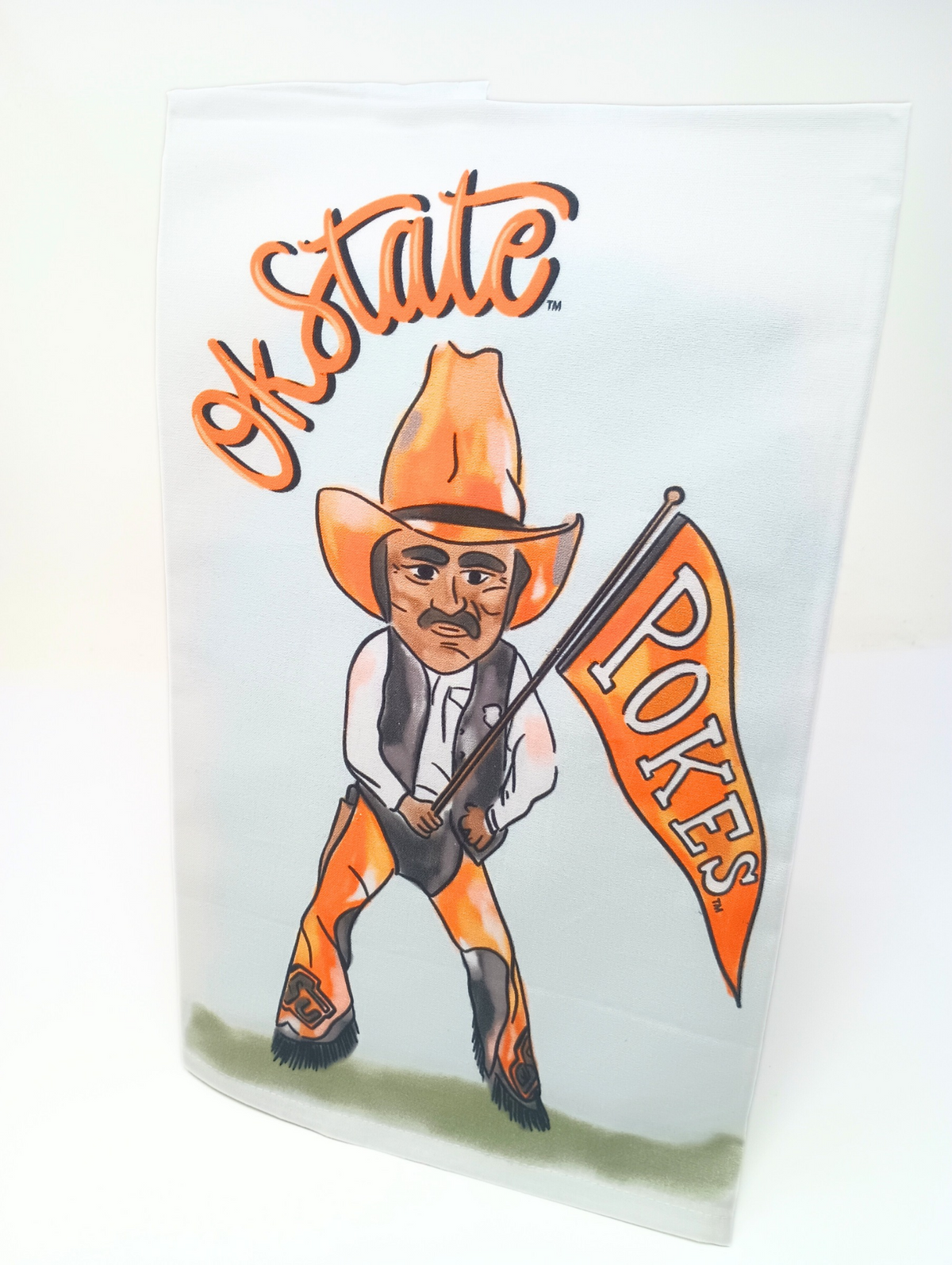 Oklahoma State Mascot Tea Towel featuring Pistol Pete holding a Pokes flag on a white background.