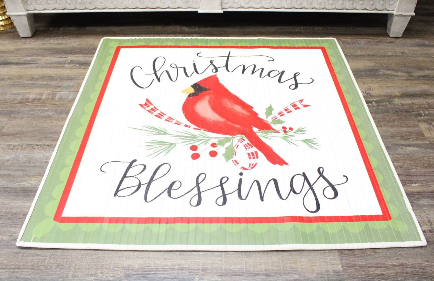 Square bamboo mat with a cardinal bird illustration surrounded by Christmas blessing text.