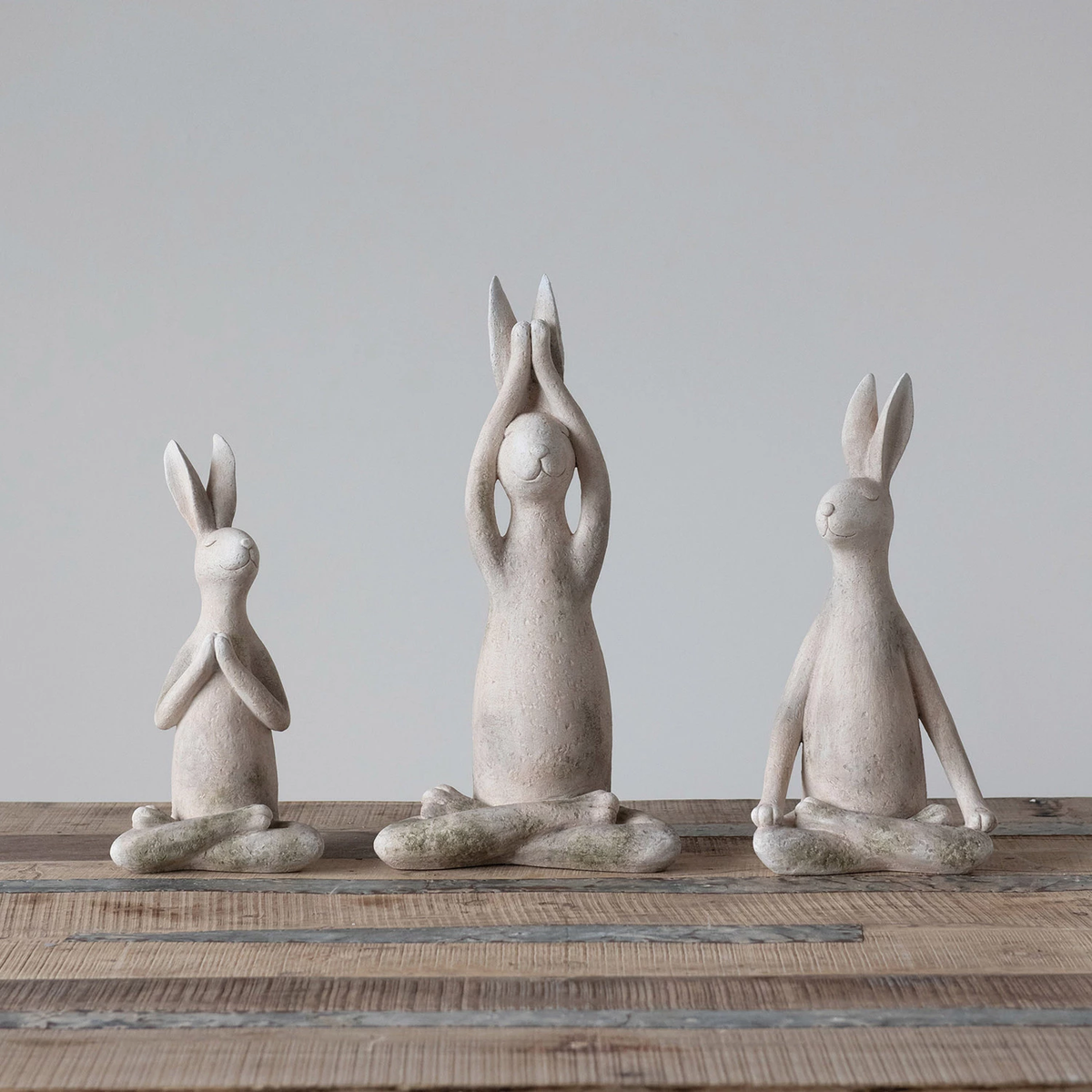 Antique white resin yoga rabbit figurine with a distressed finish.