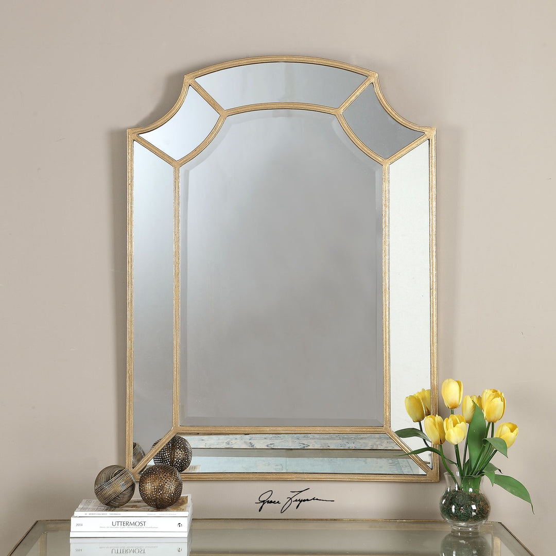 Gold arch-shaped wall mirror with a sleek metallic frame.