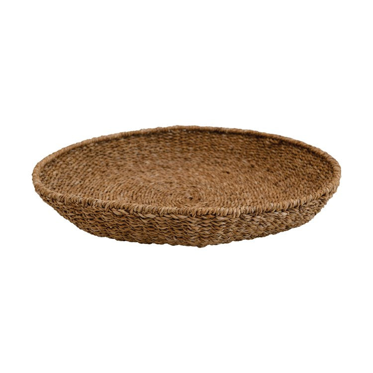 Round hand-woven seagrass tray in natural brown with a textured woven pattern.