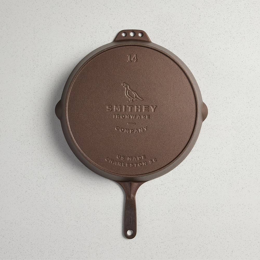 Bottom view of a No. 14 Traditional Skillet showing the Smithey Ironware logo and 14 inch marking.