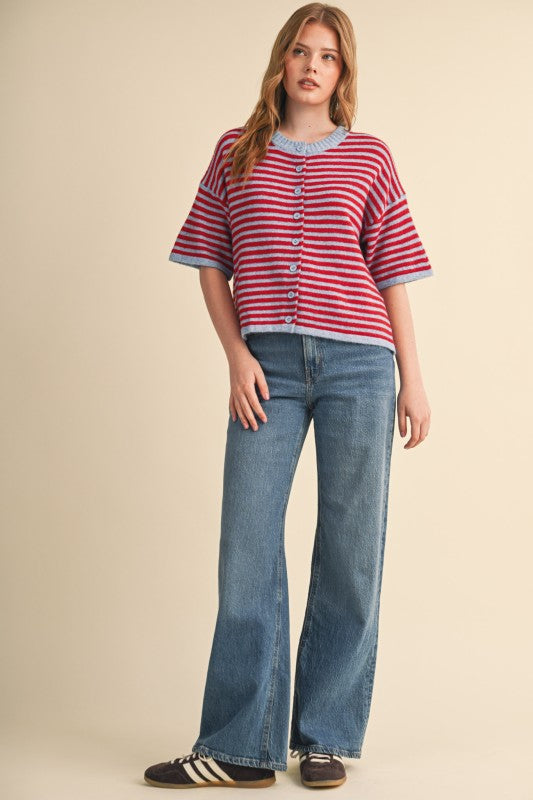 Model wearing a red and light blue Ivy Striped Short Sleeve Sweater Cardigan with wide-leg jeans.